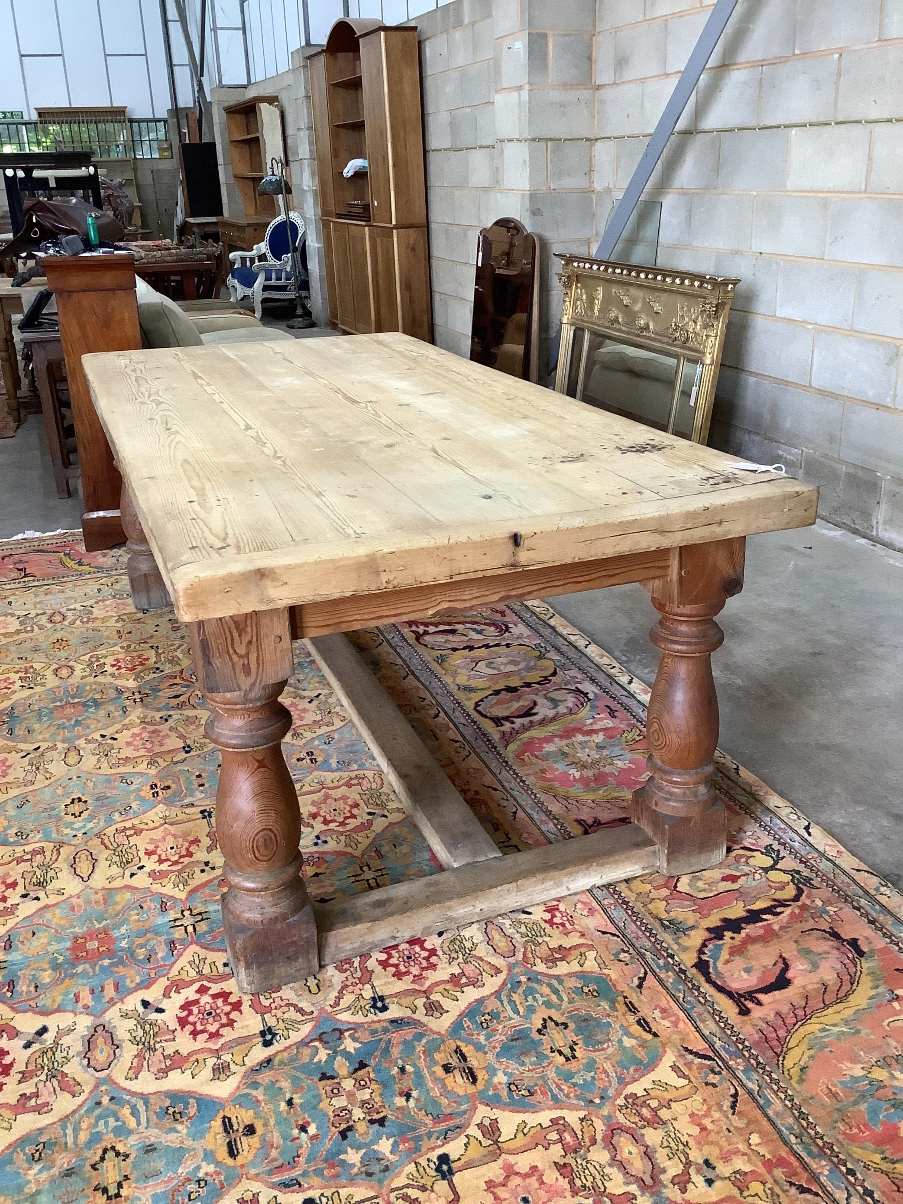 An 18th century style rectangular pine refectory dining table, width 220cm, depth 102cm, height 78cm. Condition - fair